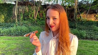 Liz Rainbow Smoking a Flor De Oliva Cigar Outdoors