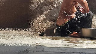 Indian sister-in-law is bathing in the open courtyard of the house, putting a finger in her burrow and rubbing the body, sister-in-law is washing the bathroom.