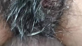 Close up view on a hairy and creamy pussy