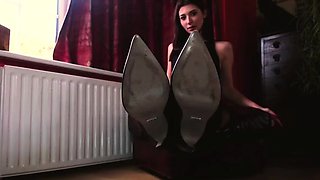 Femdom foot mistress posing seductively in black boots