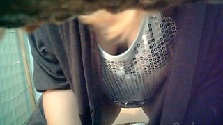 Cute white girl with big breasts pisses in the public toilet room on cam