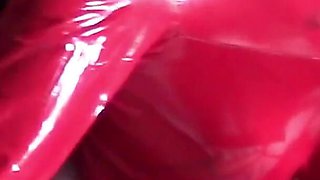 MILF in Red Latex Suit and Patent Leather High Heels Gives a Blowjob with Swallow