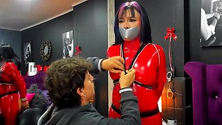 An emo asian in red catsuit tied & gagged