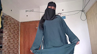 Shy muslim girl taking off burqa slowly