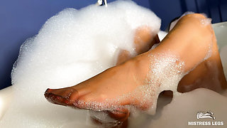 Goddess takes a foam bath in tan pantyhose and shows her wet nylon soles