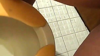 She is pissing standing to the toilet