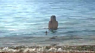 Hairy chick Riana S makes a splash at the beach - WeAreHairy