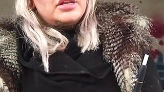 Blonde lady smokes an electronic cigarette