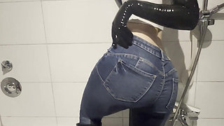 Latex teen girl is pissing in rubber boots and jeans