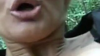 An overly horny blonde MILF lets herself be filmed in the woods masturbating her pussy while being filmed in close up