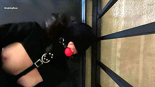Gagged and Hooded Slave struggles in Straitjacket While In Cage