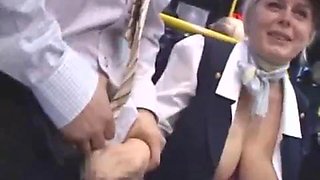 Busty blonde flight attendant jerks off Asian dude in public