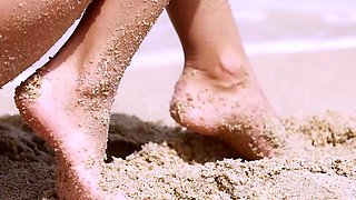 Smoking hot nude teen posing in the sand