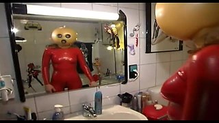 Sexual Slave in Latex Dress and a Grotesque Mask Is Waiting for a Punishment