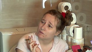 Hot babe enjoying morning smoke and coffee in bathroom