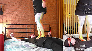 Mistress in opaque pantyhose trampling and standing on slave face