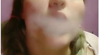 Pink braids and a cigarette in slow seduction