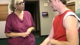 Milf Carey Riley strokes a young guys dick in the office