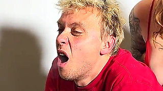 Femdom. He Smokes a Cigarette and a Busty Woman Fucks Him Hard in the Ass with a Strapon.