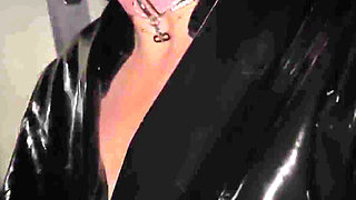 Submissive Whore in Latex with Hood and Gag in Car Exhibited