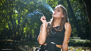 Seductive Russian Beauty Smoking Cigarette in Studio