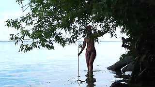 Fishing with harpoon in topless