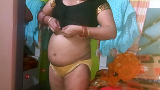 Indian housewife is wearing a yellow saree.