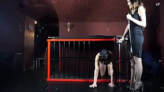 Dominatrix Commands Bound Slave in Cage