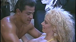 Busty blond pornstar rides stud's cock indoors in yellow corset