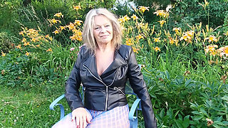 A Mature Woman Is Wearing Sheer Tights Outside.
