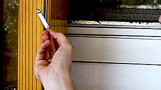 Shaved Head Goth Smokes Outside