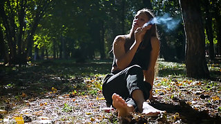 Seductive Russian Beauty Smoking Cigarette in Studio
