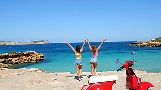 Two hot girls have fun on the beach with their bikinis on