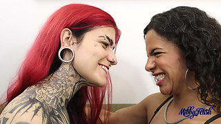 Mibby and Devil Goddess Engage in an Intense Moment of Face-licking